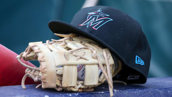 Apr 24, 2024; Atlanta, Georgia, USA; A detailed view of a Miami Marlins hat and glove in the dugout before a game against the Atlanta Braves at Truist Park. Mandatory Credit: Brett Davis-Imagn Images