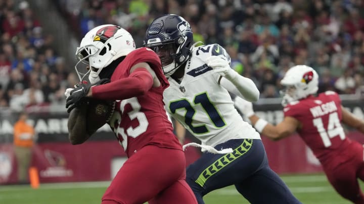 Arizona Cardinals wide receiver Greg Dortch (83) makes a catch against Seattle Seahawks cornerback Devon Witherspoon (21) during the first quarter at State Farm Stadium in Glendale on Jan. 7, 2024.