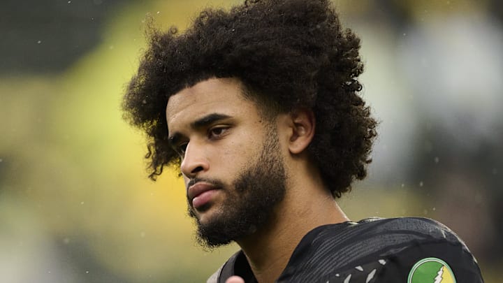 Oct 25, 2025; Eugene, Oregon, USA; Oregon Ducks quarterback Dante Moore (5) talks to officials during warm ups before a game against the Wisconsin Badgers at Autzen Stadium. The Ducks are wearing uniforms celebrating the Grateful Dead. Mandatory Credit: Troy Wayrynen-Imagn Images