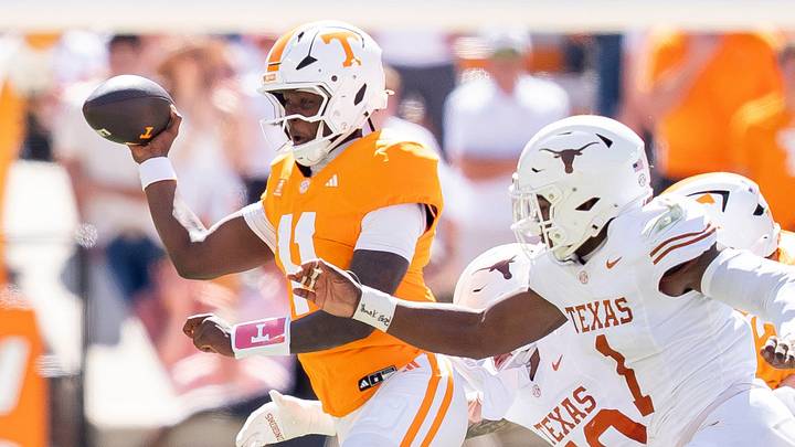 Sep 26, 2026; Knoxville, Tennessee, USA; Tennessee quarterback Faizon Brandon (11) is swarmed by Texas defenders during a college football game between Tennessee and Texas at Neyland Stadium in Knoxville, Tenn. on Sept. 26, 2026. Mandatory Credit: Brianna Paciorka-USA TODAY Network via Imagn Images