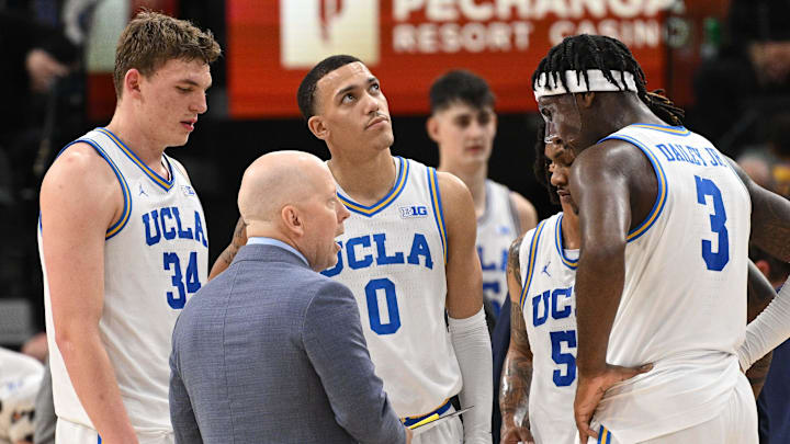 Dec 28, 2024; Inglewood, California, USA; UCLA Bruins head coach Mick Cronin talks to Tyler Bilodeau (34), Kobe Johnson (0), Dylan Andrews (2) and Eric Dailey Jr. (3) in the first half against the Gonzaga Bulldogs during a college basketball game at Intuit Dome. Mandatory Credit: Robert Hanashiro-Imagn Images