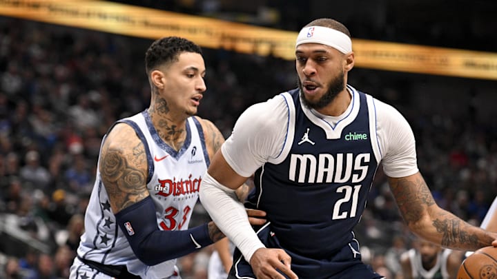 Jan 27, 2025; Dallas, Texas, USA; Dallas Mavericks center Daniel Gafford (21) looks to moves the ball past Washington Wizards forward Kyle Kuzma (33) during the first quarter at the American Airlines Center. Mandatory Credit: Jerome Miron-Imagn Images