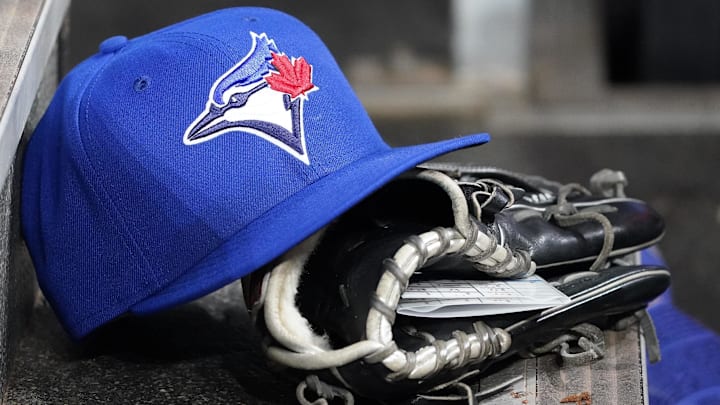 Apr 16, 2025; Toronto, Ontario, CAN; A Toronto Blue Jays hat and glove in the dugout during a game against the Atlanta Braves at Rogers Centre.  