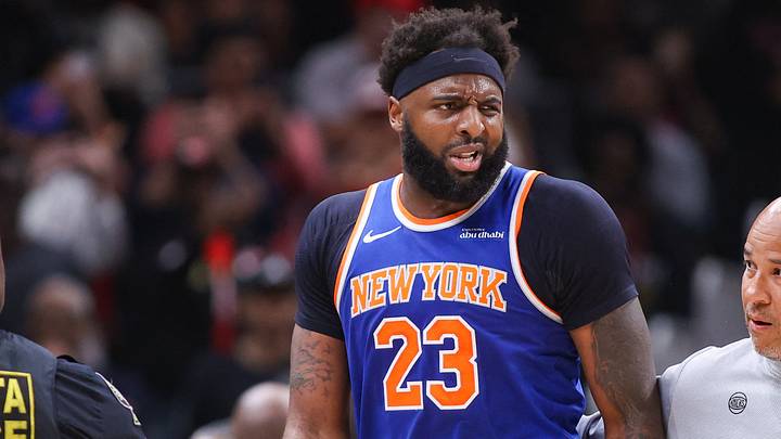 Apr 30, 2026; Atlanta, Georgia, USA; New York Knicks center Mitchell Robinson (23) is restrained by assistant coach Rick Brunson against the Atlanta Hawks in the second quarter during game six of the first round of the 2026 NBA Playoffs at State Farm Arena. Mandatory Credit: Brett Davis-Imagn Images
