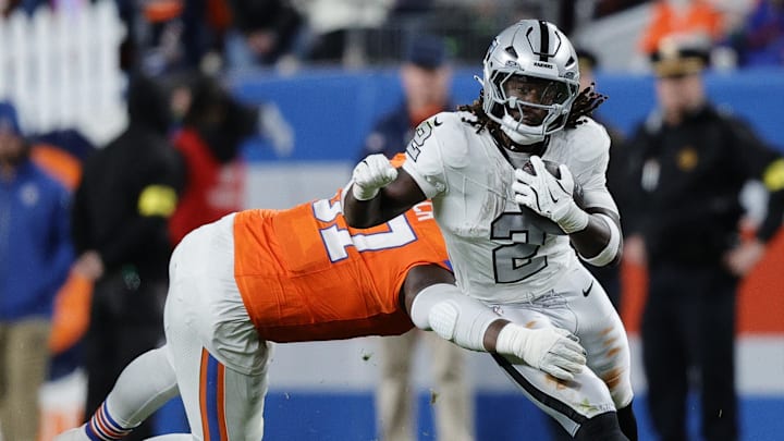 Nov 6, 2025; Denver, Colorado, USA; Las Vegas Raiders running back Ashton Jeanty (2) rushes the ball against the Denver Broncos during the first half at Empower Field at Mile High. Mandatory Credit: Isaiah J. Downing-Imagn Images