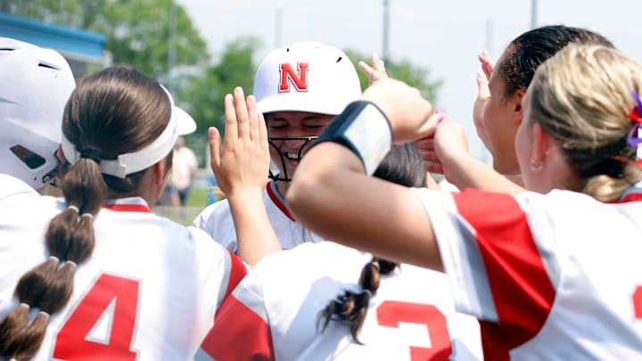 Neshannock catcher Gabby Quinn, center, smiles as she mobbed by teammates after hitting a solo home run in the fifth inning of a PIAA Class 2A quarterfinal Thursday at Norwin High School. The Lancers won 5-3.