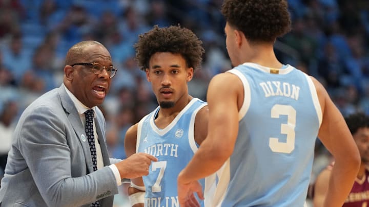 Dec 30, 2025; Chapel Hill, North Carolina, USA; North Carolina Tar Heels head coach Hubert Davis with guard Seth Trimble (7) and guard Derek Dixon (3) in the second half at Dean E. Smith Center. Mandatory Credit: Bob Donnan-Imagn Images