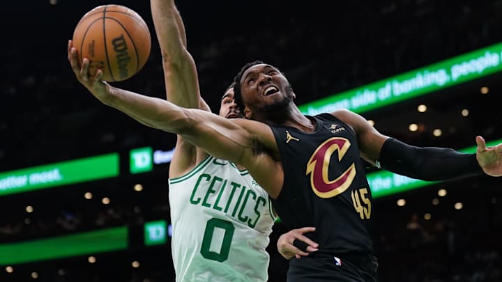 May 9, 2024; Boston, Massachusetts, USA; Cleveland Cavaliers guard Donovan Mitchell (45) shoots against Boston Celtics forward Jayson Tatum (0) in the first quarter during game two of the second round for the 2024 NBA playoffs at TD Garden. Mandatory Credit: David Butler II-Imagn Images