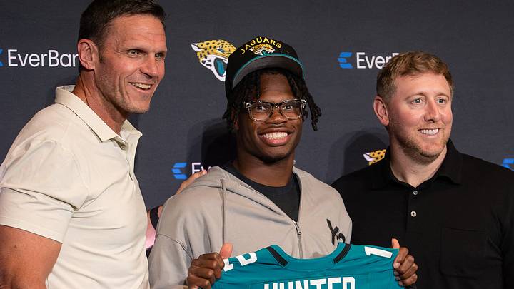 Apr 25, 2025; Jacksonville, FL, USA; Jacksonville Jaguars first round draft pick Travis Hunter poses for a photo with executive vice president of football operations Tony Boselli, head coach Liam Coen, and general manager James Gladstone, during a press conference at Miller Electric Center. Mandatory Credit: Travis Register-Imagn Images Apr 25, 2025; Jacksonville, FL, USA; Jacksonville Jaguars first round draft pick Travis Hunter poses for a photo with executive vice president of football operations Tony Boselli, head coach Liam Coen, and general manager James Gladstone, during a press conference at Miller Electric Center. Mandatory Credit: Travis Register-Imagn Images