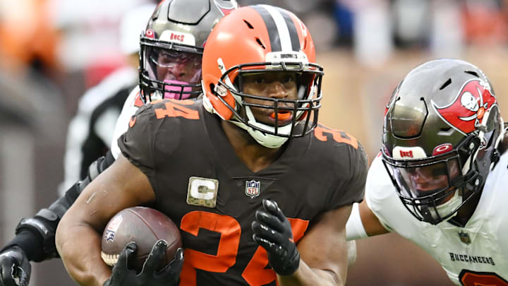 Nov 27, 2022; Cleveland, Ohio, USA; Cleveland Browns running back Nick Chubb (24) runs with the ball as Tampa Bay Buccaneers linebacker Joe Tryon-Shoyinka (9) pursues during the first half at FirstEnergy Stadium. Mandatory Credit: Ken Blaze-Imagn Images