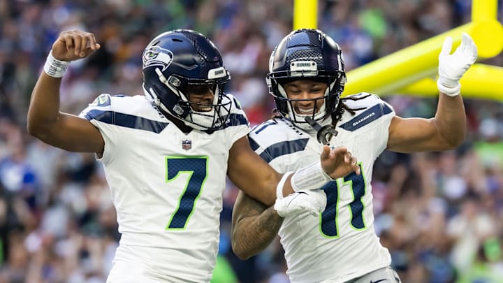 Dec 8, 2024; Glendale, Arizona, USA; Seattle Seahawks quarterback Geno Smith (7) celebrates a touchdown with wide receiver Jaxon Smith-Njigba (11) against the Arizona Cardinals in the first half at State Farm Stadium.