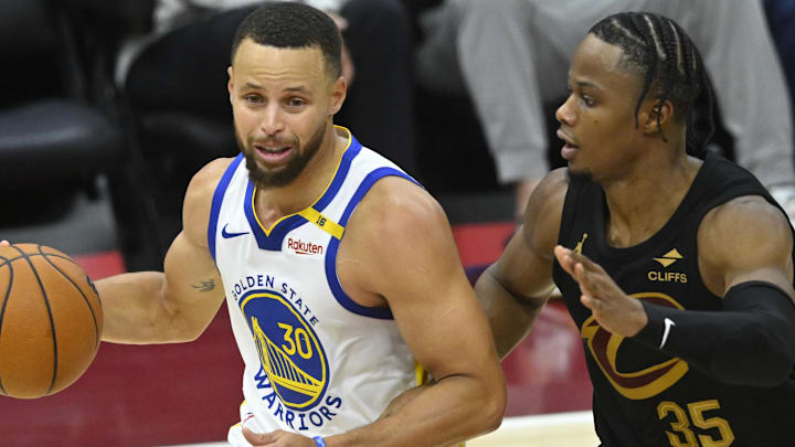 Nov 8, 2024; Cleveland, Ohio, USA; Golden State Warriors guard Stephen Curry (30) dribbles beside Cleveland Cavaliers forward Isaac Okoro (35) in the third quarter at Rocket Mortgage FieldHouse. Mandatory Credit: David Richard-Imagn Images