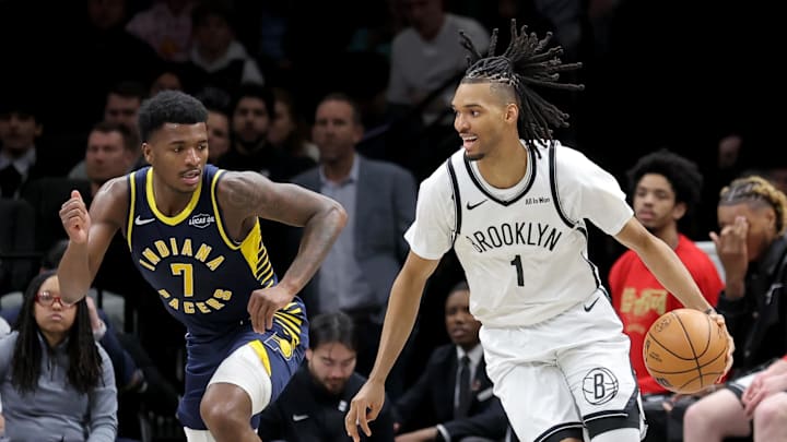 Feb 11, 2026; Brooklyn, New York, USA; Brooklyn Nets forward Ziaire Williams (1) controls the ball against Indiana Pacers guard Kam Jones (7) during the third quarter at Barclays Center. Mandatory Credit: Brad Penner-Imagn Images