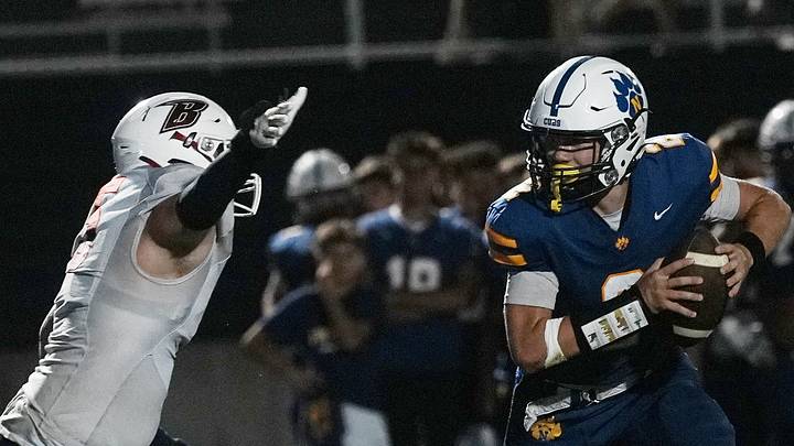 Nevada's quarterback Colton Pedersen (2) rushes with the ball after evading a tackle by Ballard defensive lineman/fullback Leif Jorgensen during the fourth quarter of a Week 3 high school football game at Cub Stadium on Sept. 11, 2026, in Nevada, Iowa. Nevada's quarterback Colton Pedersen (2) rushes with the ball after evading a tackle by Ballard defensive lineman/fullback Leif Jorgensen during the fourth quarter of a Week 3 high school football game at Cub Stadium on Sept. 11, 2026, in Nevada, Iowa.