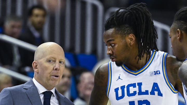 Nov 4, 2024; Los Angeles, California, USA; UCLA Bruins head coach Mick Cronin with guards Sebastian Mack (12) and Dylan Andrews (2) during the first half against the Rider Broncs  at Pauley Pavilion presented by Wescom. Mandatory Credit: Robert Hanashiro-Imagn Images