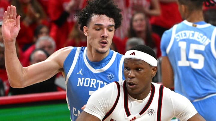 Feb 17, 2026; Raleigh, North Carolina, USA; NC State Wolfpack forward Ven-Allen Lubin (22) drives the ball to the basket against North Carolina Tar Heels forward Zayden High (1) during the first half at Lenovo Center. Mandatory Credit: Zachary Taft-Imagn Images