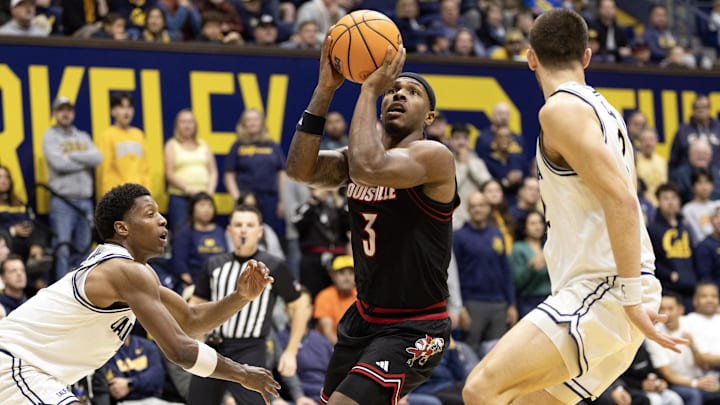 Dec 30, 2025; Berkeley, California, USA; Louisville Cardinals guard Ryan Conwell (3) shoots between California Golden Bears defenders Dai Dai Ames (7) and John Camden (2) during the first half at Haas Pavilion. Mandatory Credit: D. Ross Cameron-Imagn Images Dec 30, 2025; Berkeley, California, USA; Louisville Cardinals guard Ryan Conwell (3) shoots between California Golden Bears defenders Dai Dai Ames (7) and John Camden (2) during the first half at Haas Pavilion. Mandatory Credit: D. Ross Cameron-Imagn Images