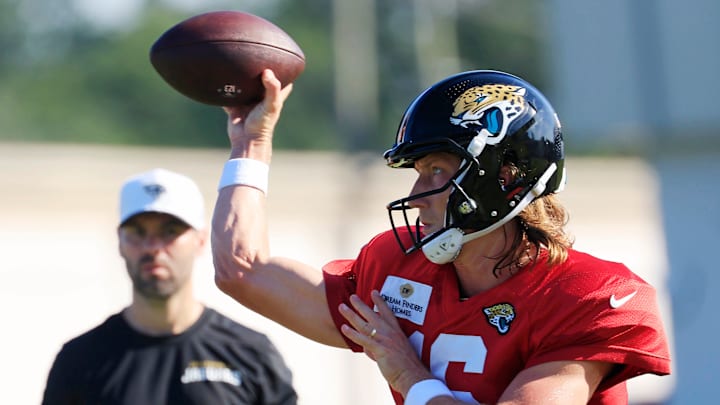 Jacksonville Jaguars quarterback Trevor Lawrence (16) throws the ball as quaterbacks coach Spencer Whipple looks on during an NFL training camp session at the Miller Electric Center, Tuesday, July 29, 2025, in Jacksonville, Fla. [Corey Perrine/Florida Times-Union]