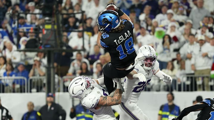 Dec 25, 2025; Minneapolis, Minnesota, USA; Detroit Lions wide receiver Isaac Teslaa (18) makes a catch for a touchdown defended by Minnesota Vikings linebacker Blake Cashman (51) and safety Harrison Smith (22) in the second quarter at U.S. Bank Stadium.