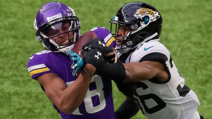 Dec 6, 2020; Minneapolis, Minnesota, USA; Minnesota Vikings wide receiver Justin Jefferson (18) catches a pass in the third quarter against the Jacksonville Jaguars defensive back Luq Barcoo (36) at U.S. Bank Stadium. Mandatory Credit: Brad Rempel-Imagn Images Dec 6, 2020; Minneapolis, Minnesota, USA; Minnesota Vikings wide receiver Justin Jefferson (18) catches a pass in the third quarter against the Jacksonville Jaguars defensive back Luq Barcoo (36) at U.S. Bank Stadium. Mandatory Credit: Brad Rempel-Imagn Images