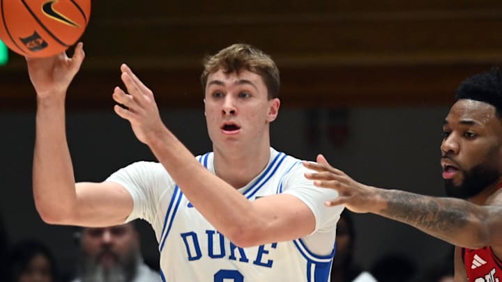 Jan 27, 2025; Durham, North Carolina, USA; Duke Blue Devils forward Cooper Flagg (2) throws a pass as North Carolina State Wolfpack guard Dontrez Styles (3) defends during the first half at Cameron Indoor Stadium. Mandatory Credit: Rob Kinnan-Imagn Images