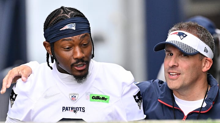 Jun 9, 2025; Foxborough, MA, USA; New England Patriots offensive coordinator Josh McDaniels (r) walks to the practice field with his arm around wide receiver Stefon Diggs (8) before  minicamp at Gillette Stadium. Mandatory Credit: Eric Canha-Imagn Images
