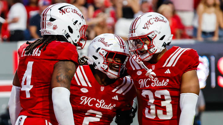 Aug 28, 2025; Raleigh, North Carolina, USA; North Carolina State Wolfpack safety Ronnie Royal III (2), linebacker Tra Thomas (4) and linebacker Kenny Soares Jr. (33) celebrate during the first half of the game against East Carolina Pirates at Carter-Finley Stadium. Mandatory Credit: Jaylynn Nash-Imagn Images Aug 28, 2025; Raleigh, North Carolina, USA; North Carolina State Wolfpack safety Ronnie Royal III (2), linebacker Tra Thomas (4) and linebacker Kenny Soares Jr. (33) celebrate during the first half of the game against East Carolina Pirates at Carter-Finley Stadium. Mandatory Credit: Jaylynn Nash-Imagn Images