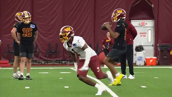 Washington Commanders QB Jayden Daniels drops back to pass to RB Rachaad White at mandatory minicamp.