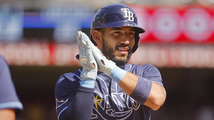 Tampa Bay Rays pinch hitter Jose Caballero (77) celebrates his sacrifice bunt that scored a run against the Minnesota Twins in the 10th inning at Target Field. Tampa Bay Rays pinch hitter Jose Caballero (77) celebrates his sacrifice bunt that scored a run against the Minnesota Twins in the 10th inning at Target Field.