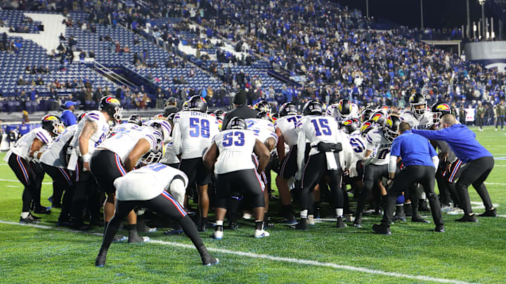 Nov 16, 2024; Provo, Utah, USA; The Kansas Jayhawks huddle before the game against the Brigham Young Cougars at LaVell Edwards Stadium. Mandatory Credit: Rob Gray-Imagn Images