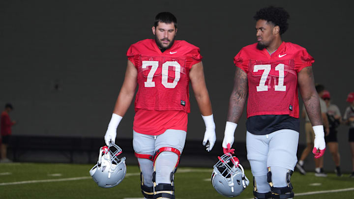 Aug 3, 2023; Columbus, OH, USA; Josh Fryar (left) and Josh Simmons walk on the field befofre the first football practice of the 2023 season at the Woody Hayes Athletic Center. Mandatory Credit: Doral Chenoweth-The Columbus Dispatch Aug 3, 2023; Columbus, OH, USA; Josh Fryar (left) and Josh Simmons walk on the field befofre the first football practice of the 2023 season at the Woody Hayes Athletic Center. Mandatory Credit: Doral Chenoweth-The Columbus Dispatch