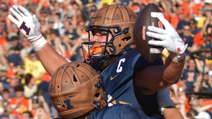 Oct 19, 2024; Champaign, Illinois, USA;  Illinois Fighting Illini tight end Tanner Arkin (85) reacts after scoring a touchdown against the Michigan Wolverines during the first half at Memorial Stadium. Mandatory Credit: Ron Johnson-Imagn Images