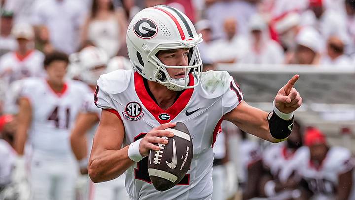 Georgia Bulldogs quarterback Gunner Stockton (14) rolls out and runs against the Western Kentucky Hilltoppers during the first half at Sanford Stadium. 