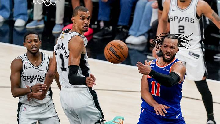 Jun 13, 2026; San Antonio, Texas, USA; New York Knicks guard Jalen Brunson (11) passes the ball around San Antonio Spurs forward Victor Wembanyama (1) in the second half during Game 5 of the 2026 NBA Finals at Frost Bank Center.