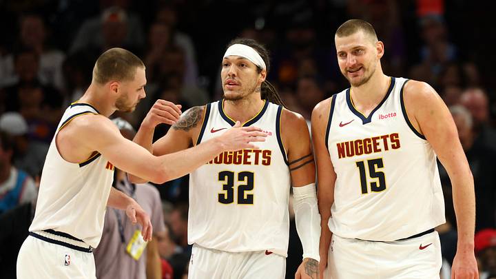 Mar 24, 2026; Phoenix, Arizona, USA; Denver Nuggets guard Christian Braun (0) celebrates with forward Aaron Gordon (32) and center Nikola Jokic (15) against the Phoenix Suns in the first half at Mortgage Matchup Center.