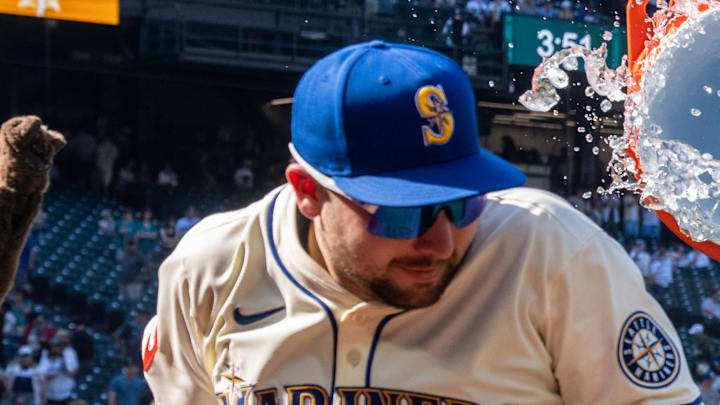 Seattle Mariners centerfielder Julio Rodriguez (44), right, attempts to douse catcher Cal Raleigh (29) with water after a game against the Athletics at T-Mobile Park on Aug. 24.