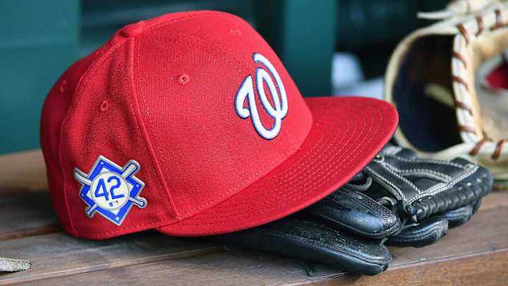 Red Washington Nationals hat on top of a black mitt Red Washington Nationals hat on top of a black mitt