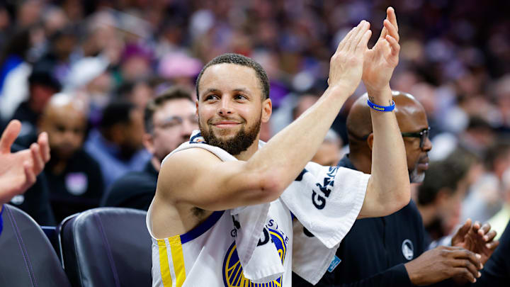 Feb 21, 2025; Sacramento, California, USA; Golden State Warriors guard Stephen Curry (30) claps from the bench during the fourth quarter against the Sacramento Kings at Golden 1 Center. Mandatory Credit: Sergio Estrada-Imagn Images