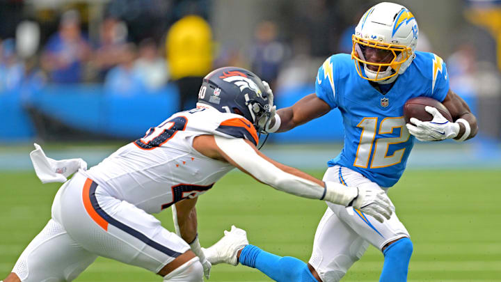 Sep 21, 2025; Inglewood, California, USA;  Los Angeles Chargers wide receiver Derius Davis (12) runs for a first down before he is stopped by Denver Broncos linebacker Justin Strnad (40) and cornerback Ja'Quan McMillian (29) in the first half against the Los Angeles Chargers at SoFi Stadium. 