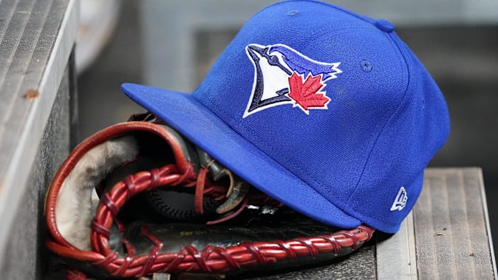 Apr 16, 2025; Toronto, Ontario, CAN; A Toronto Blue Jays hat and glove in the dugout during a game against the Atlanta Braves at Rogers Centre. 