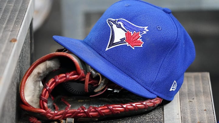 Apr 16, 2025; Toronto, Ontario, CAN; A Toronto Blue Jays hat and glove in the dugout during a game against the Atlanta Braves at Rogers Centre. 