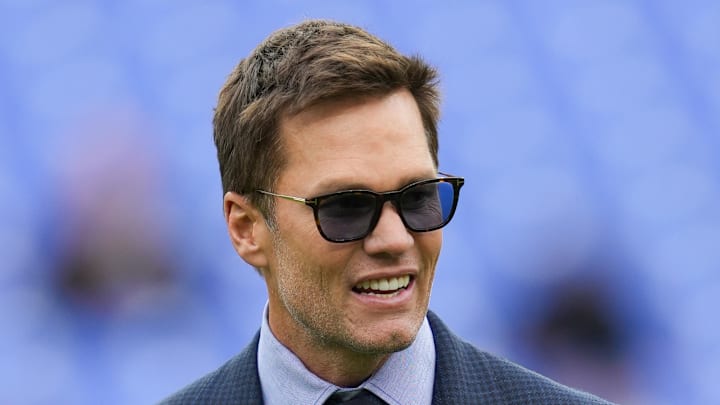 Oct 12, 2025; Baltimore, Maryland, USA; Fox Sports announcer Tom Brady looks on before the game between the Baltimore Ravens and the Los Angeles Rams at M&T Bank Stadium. Mandatory Credit: Mitch Stringer-Imagn Images Oct 12, 2025; Baltimore, Maryland, USA; Fox Sports announcer Tom Brady looks on before the game between the Baltimore Ravens and the Los Angeles Rams at M&T Bank Stadium. Mandatory Credit: Mitch Stringer-Imagn Images