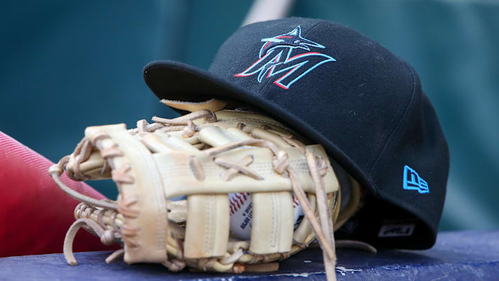 Apr 24, 2024; Atlanta, Georgia, USA; A detailed view of a Miami Marlins hat and glove in the dugout before a game against the Atlanta Braves at Truist Park. Apr 24, 2024; Atlanta, Georgia, USA; A detailed view of a Miami Marlins hat and glove in the dugout before a game against the Atlanta Braves at Truist Park.