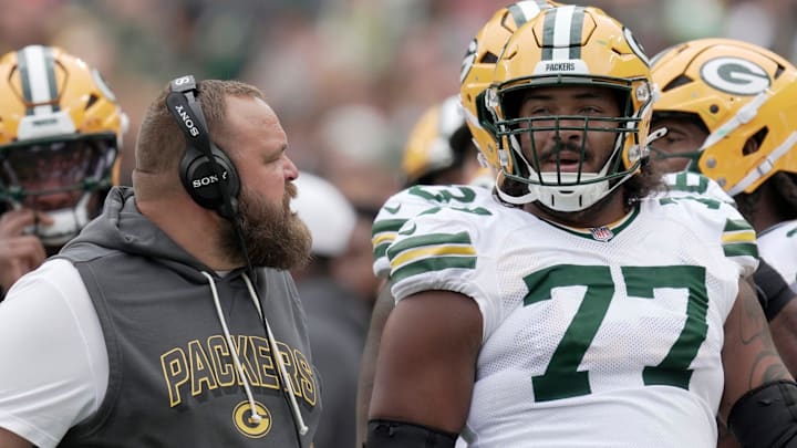 Green Bay Packers offensive tackle Jordan Morgan (77) listens to offensive line coach Luke Butkus during the first quarter of their preseason game Saturday, August 23, 2025, at Lambeau Field in Green Bay, Wisconsin.