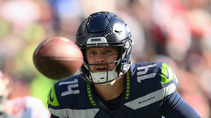Seattle Seahawks quarterback Sam Darnold pitches the ball to running back Emanuel Wilson. Seattle Seahawks quarterback Sam Darnold pitches the ball to running back Emanuel Wilson.