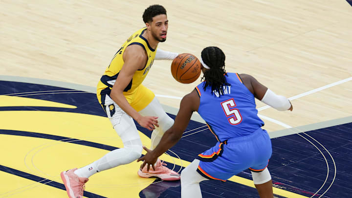 Indiana Pacers guard Haliburton dribbles the ball defended by Oklahoma City Thunder guard Dort during the 2025 NBA Finals at Gainbridge Fieldhouse. 