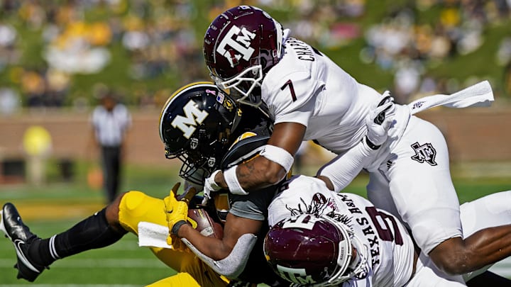 Oct 16, 2021; Columbia, Missouri, USA; Missouri Tigers wide receiver Tauskie Dove (86) is tackled by Texas A&MM Aggies defensive back Tyreek Chappell (7) and defensive back Leon O'Neal Jr. (9) during the second half at Faurot Field at Memorial Stadium. 