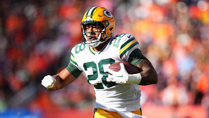 Oct 22, 2023; Denver, Colorado, USA; Green Bay Packers running back AJ Dillon (28) carries the ball in the second quarter against the Denver Broncos at Empower Field at Mile High. Mandatory Credit: Ron Chenoy-Imagn Images