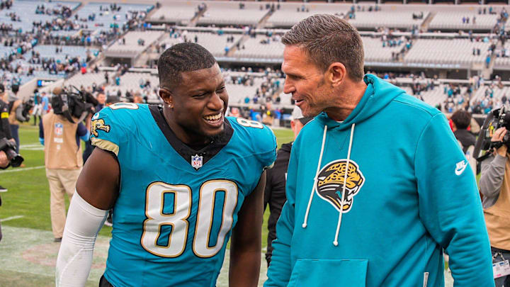 Jacksonville Jaguars tight end Quintin Morris (80) has a laugh with Jacksonville Jaguars Executive Vice President of Football Operations Tony Boselli after the game at EverBank Stadium, Sunday, Jan. 4, 2026, in Jacksonville, Fla. The Jaguars defeated the Titans 41-7 [Doug Engle/Florida Times-Union]