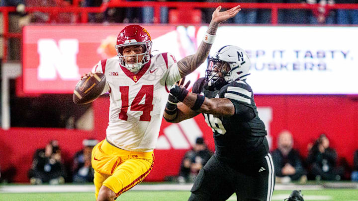 Southern California Trojans quarterback Jayden Maiava runs against Nebraska Cornhuskers defensive lineman Elijah Jeudy.